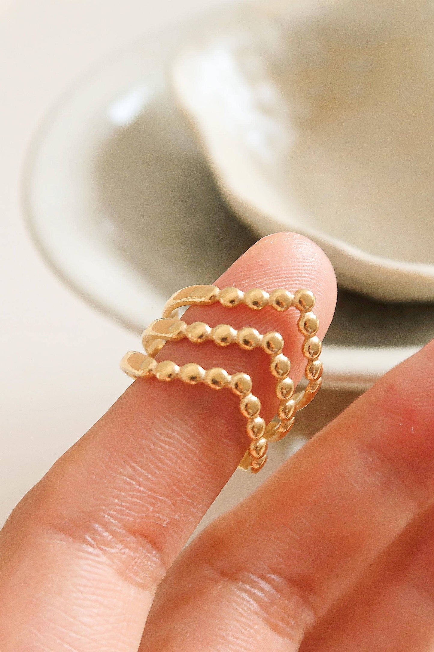 Gold ring on a finger with a blurred background