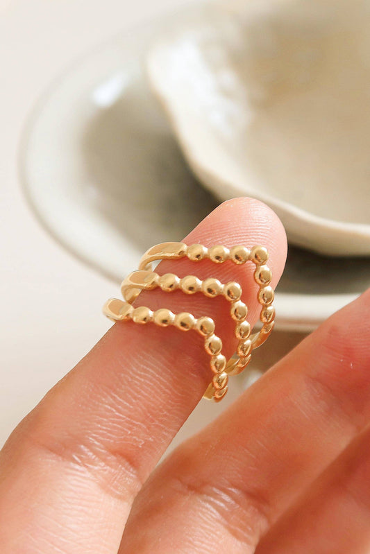 Gold ring on a finger with a blurred background