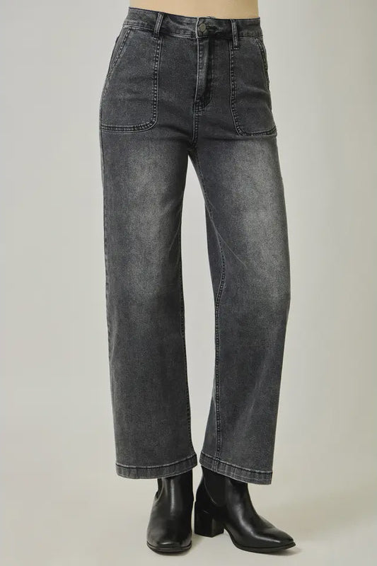 Black jeans worn by a person on a light gray background