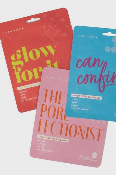 Three sheet mask packages with colorful text on a light gray background