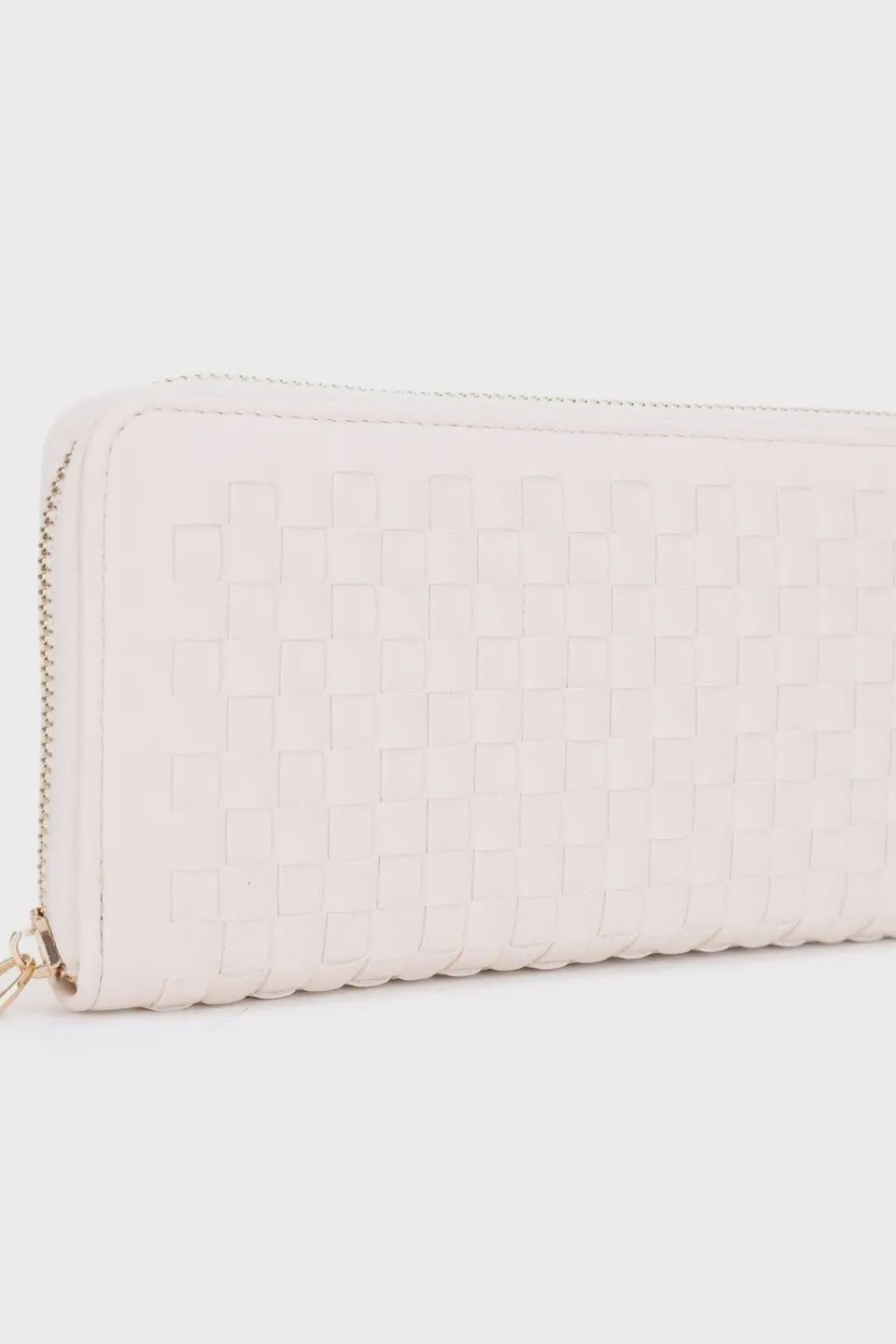 Light pink quilted wallet on a light gray background