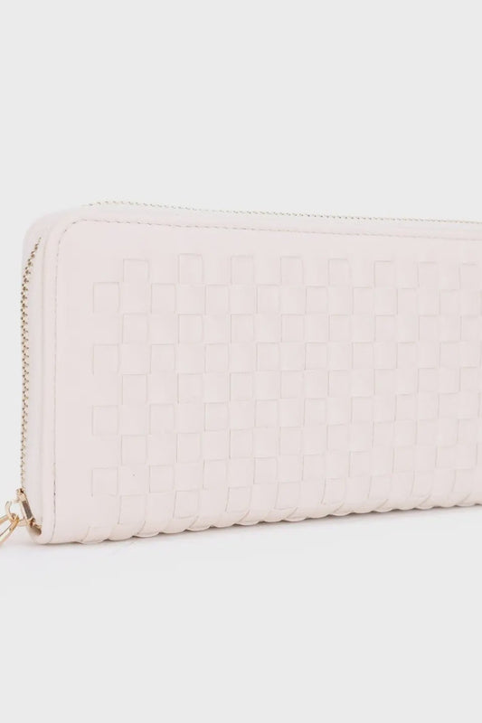 Light pink quilted wallet on a light gray background
