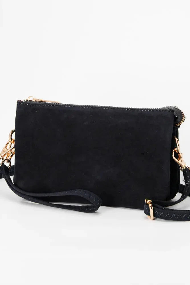Navy handbag with a strap on a white background