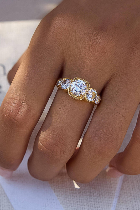 Gold ring with multiple diamonds on a person's finger