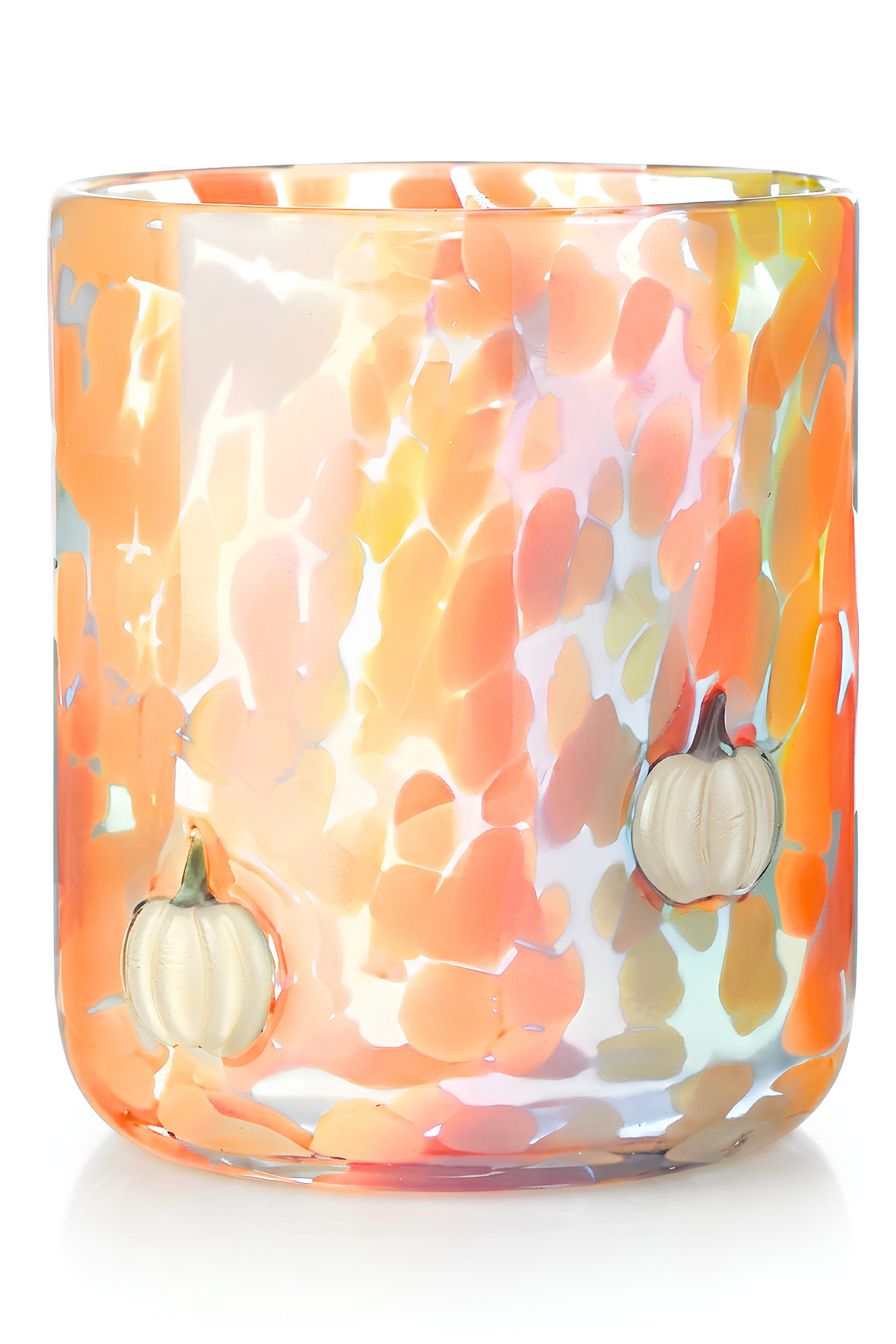 An iridescent orange glass candle holder with a hammered texture and two small 3D pumpkins on the front, set against a plain white background.