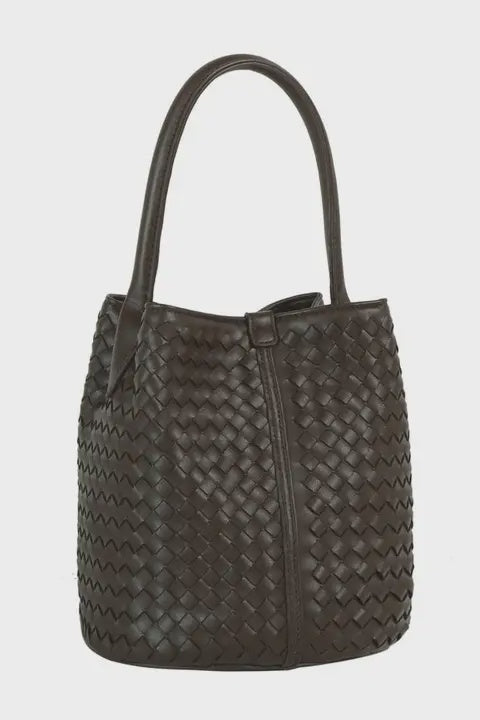 Dark woven handbag on a light gray background