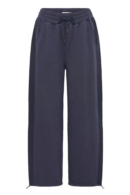 Navy blue pants with a drawstring on a white background