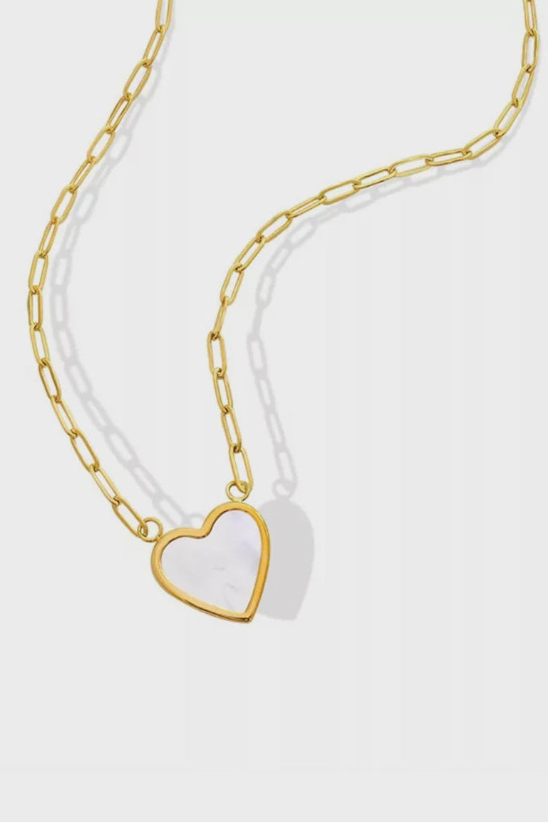 Gold chain necklace with a heart-shaped pendant on a white background
