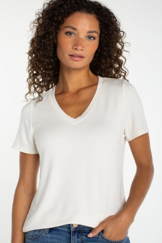 Woman wearing a plain white t-shirt against a white background
