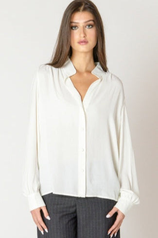 Woman wearing a white blouse with a plain background