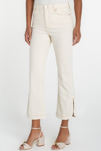 Person wearing white jeans on a plain background