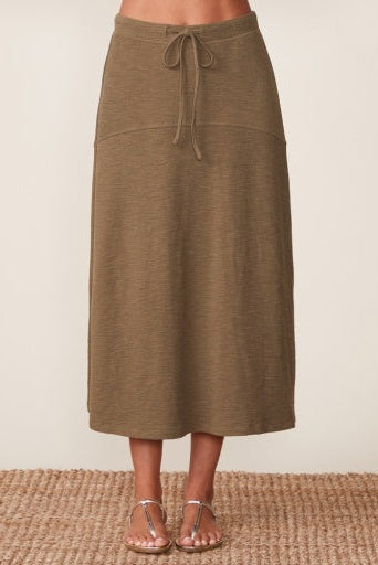Brown skirt worn by a person on a beige background