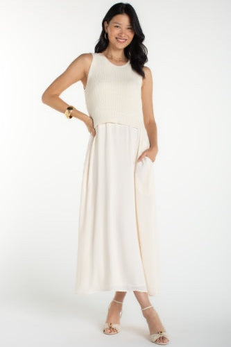 Woman wearing a white sleeveless dress on a white background