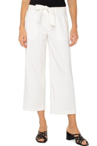 White wide-leg pants with a tie waist worn by a person on a white background