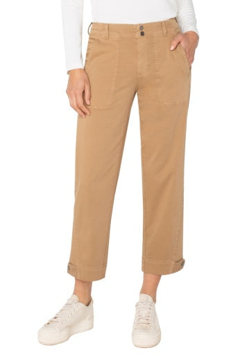 Person wearing tan pants and white sneakers on a white background