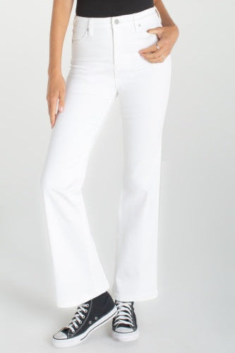 Person wearing white jeans and black sneakers on a white background