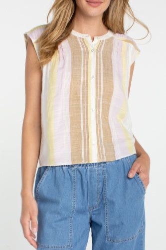 Woman wearing a sleeveless striped top and blue pants on a white background