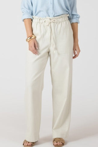 Person wearing light-colored pants and a light blue shirt on a white background