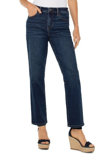 Person wearing dark blue jeans on a white background