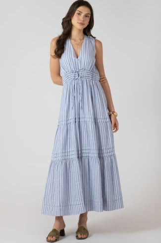 Woman wearing a blue and white striped dress on a white background