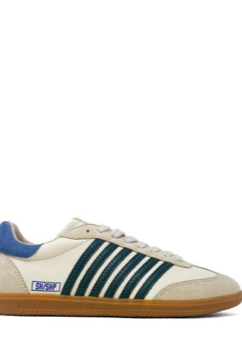 Beige sneaker with green stripes and blue accents on a white background