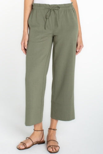 Person wearing olive green pants on a white background