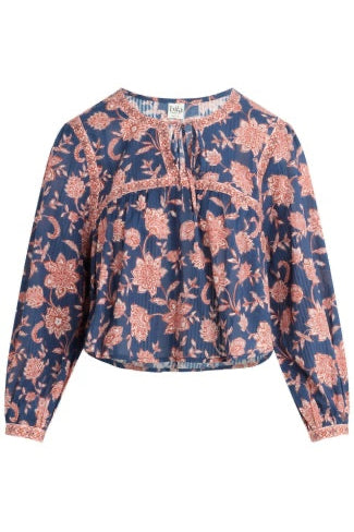 A long-sleeve bohemian-style blouse with a navy blue base and a dusty rose floral block print, featuring a tie-neck detail and a gathered peplum waist.