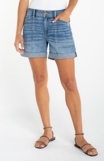 Person wearing blue denim shorts on a white background