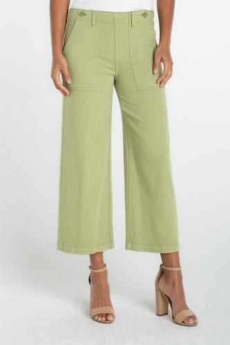 Person wearing light green pants on a white background