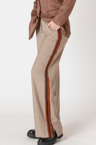Beige checkered pants with brown side stripes worn by a person on a white background