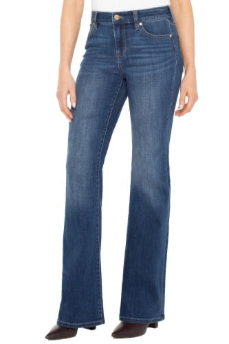 Blue jeans worn by a person on a white background