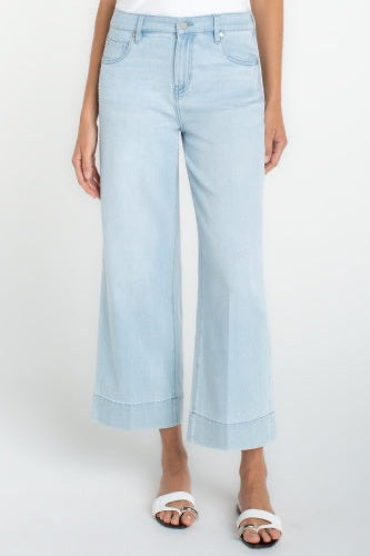 Light blue jeans worn by a person on a white background