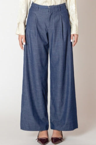 Blue wide-leg pants worn by a person on a plain background