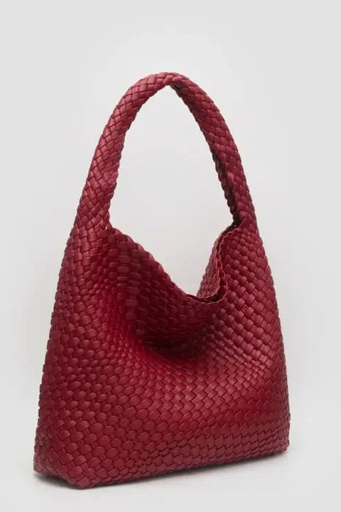 Red woven handbag on a light gray background