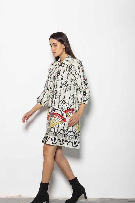 Woman wearing a patterned dress with a white background