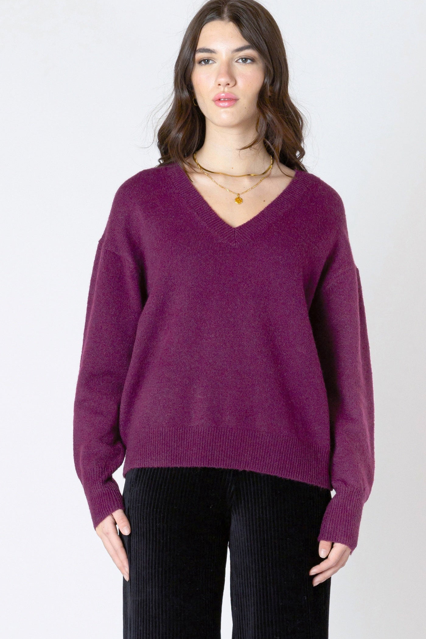 Woman wearing a purple sweater on a white background