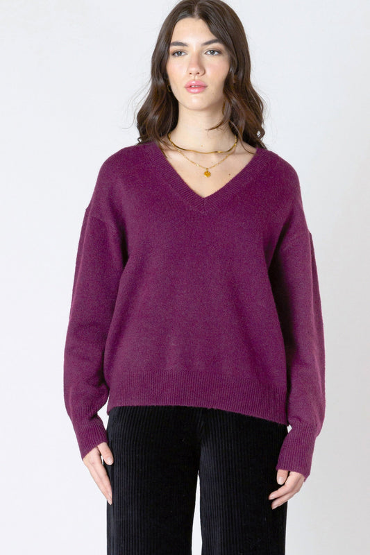 Woman wearing a purple sweater on a white background