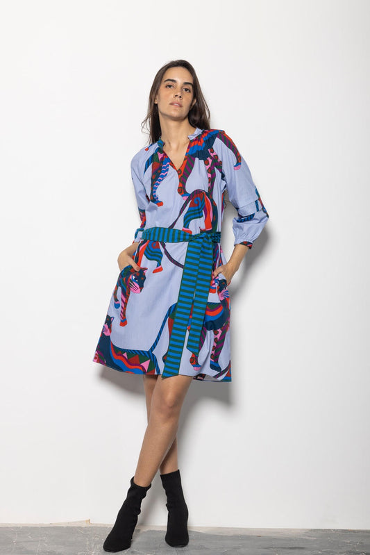 Woman wearing a colorful dress with abstract patterns on a white background